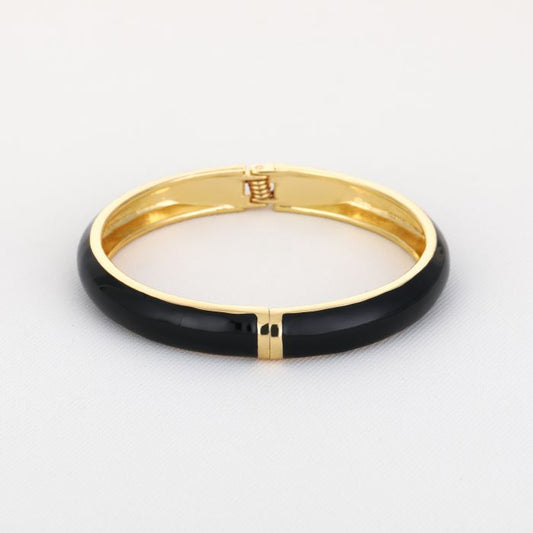 Goudkleurige stainless steel bangle met zwarte afwerking